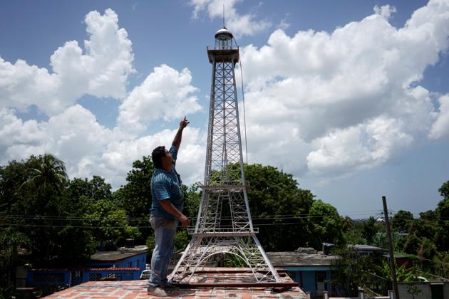 Jorge Enrique Salgado explains how he built a replica of the Eiffel Tower on the roof of his home in Havana, Cuba, August 6, 2020. Picture taken August 6, 2020. REUTERS/Alexandre Meneghini (REUTERS)