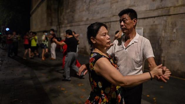 Couples dance next to the Yangtze River in Wuhan on August 5. Wuhan’s recovery after a 76-day lockdown was lifted in April has brought life back onto its streets. (Hector Retamal / AFP)