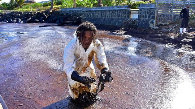 A volunteer works to clear leaked oil from Wakashio at Riviere des Creoles in Mauritius on August 10. “My friends and I came here today to lend a hand because of the degradation of our environment. The entire marine ecology has been affected by the heavy oil spilled from the ship. We are very affected by this problem,” Eldridge Larhubarbe, a student told AFP. (Dev Ramkhelawon / L'Express Maurice / REUTERS)