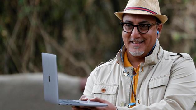Kenya’s Cabinet Secretary for Tourism and Wildlife Najib Balala uses his laptop as he witnesses wildebeests migrating to the open plains of the Serengeti, in Maasai Mara game reserve on August 8. “We are trying to revive the sector through the domestic tourism strategy. And that is why we ask Kenyans ... to support tourism,” Balala told Reuters. (Thomas Mukoya / REUTERS)