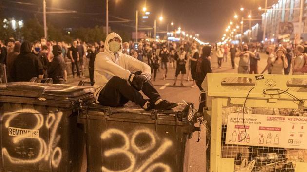 A demonstrator sits on a trash container during a rally following the presidential election in Minsk, Belarus on August 10. Rallies took place in 25 Belarusian cities on August 10 overnight to contest the election results and demand re-election, AP reported. (Jedrzej Nowicki / Agencja Gazeta via REUTERS)