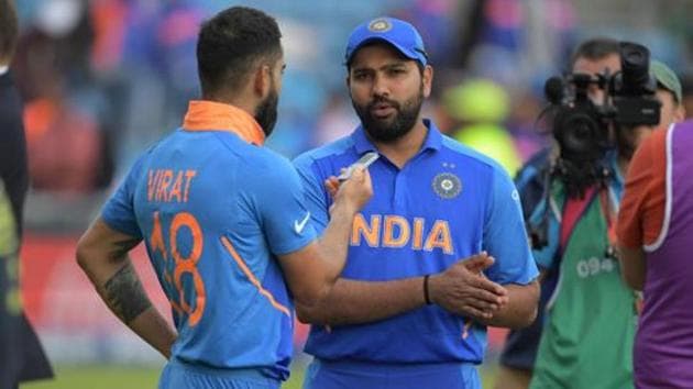 India's Rohit Sharma (C) is interviewed by India's captain Virat Kohli (L)(AFP)