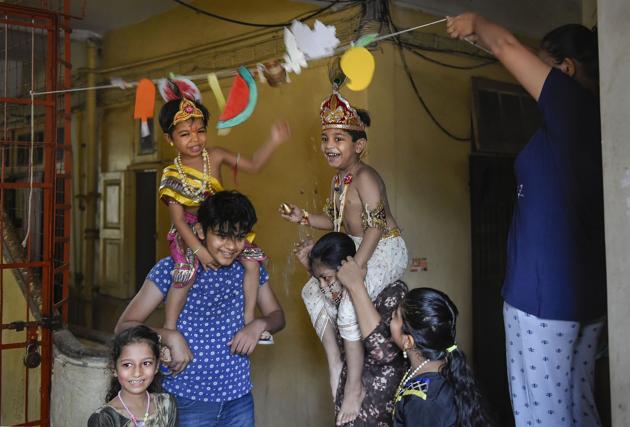 Mumbai: Children dressed as Lord Krishna and Radha break an earthen pot on the occasion of Janmashtami (Dahi Handi), at Dadar in Mumbai, Wednesday, Aug. 12, 2020. Owing to COVID-19 crisis, Dahi Handi festivities in Maharashtra were subdued as mandals opted for a low-key celebration. (PTI)