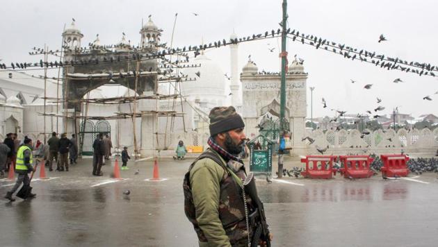 Security personnel stand guard outside Dargah Hazratbal in Srinagar, one of the city’s main religious places.(PTI FILE PHOTO)