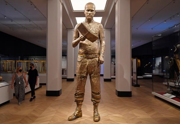 Employees walk past the sculpture 'Self-Conscious Gene' by Marc Quinn ahead of the reopening of the Science Museum, after lockdown restrictions were eased following the outbreak of the coronavirus disease (COVID-19), London, Britain, August 10, 2020. (REUTERS)