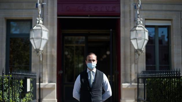 A doorman wearing a protective face mask stands outside the La Reserve hotel, one of the 12 high-end hotels in Paris that are classified as palaces, in this arranged photograph in Paris, France, on Wednesday, Aug. 12, 2020. (Bloomberg) A doorman wearing a protective face mask stands outside the La Reserve hotel, one of the 12 high-end hotels in Paris that are classified as palaces, in this arranged photograph in Paris, France, on Wednesday, Aug. 12, 2020. (Bloomberg)