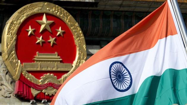 An Indian national flag is flown next to the Chinese national emblem outside the Great Hall of the People in Beijing. (AP) An Indian national flag is flown next to the Chinese national emblem outside the Great Hall of the People in Beijing. (AP)