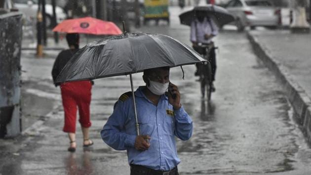 A private security guard with an umbrella speaks on a phone while it rains at South Extension in New Delhi on August 13. India’s Covid-19 caseload makes it the third worst-hit country in the world after the US and Brazil. However, the government maintains that the Covid-19 situation is improving. India’s recovery rate is currently over 70% while the death rate stands at 1.95%, among the lowest worldwide. (Biplov Bhuyan / HT Photo) A private security guard with an umbrella speaks on a phone while it rains at South Extension in New Delhi on August 13. India’s Covid-19 caseload makes it the third worst-hit country in the world after the US and Brazil. However, the government maintains that the Covid-19 situation is improving. India’s recovery rate is currently over 70% while the death rate stands at 1.95%, among the lowest worldwide. (Biplov Bhuyan / HT Photo)
