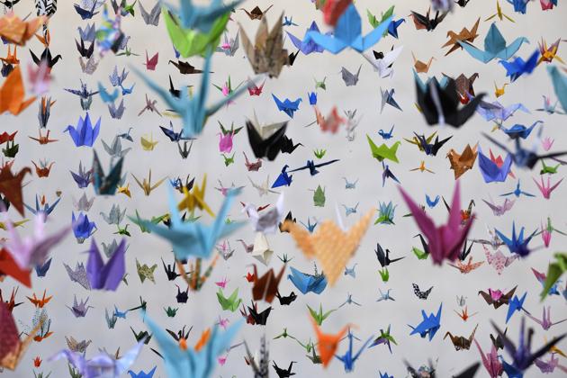 Origami paper cranes hang in the Matter Studio Gallery in Los Angeles during an exhibit for those who have died in the U.S. of COVID-19, on Tuesday, Aug. 11, 2020. Hundreds of origami now hang from the ceiling of Karla Funderburk’s Matter Studio with others sitting on tables and stacked in boxes waiting to be added to the sad reminder of the virus’ toll. (AP Photo/Richard Vogel) (AP)
