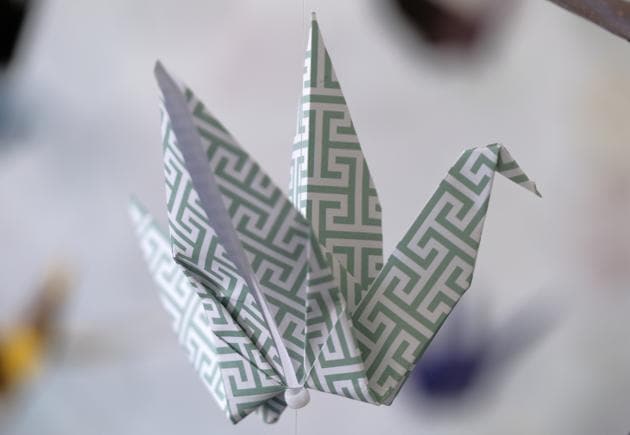 An origami paper crane hangs in the Matter Studio Gallery in Los Angeles, among thousands of others during an exhibit for those who have died in the U.S., of COVID-19, on Tuesday, Aug. 11, 2020. Hundreds of origami now hang from the ceiling of Karla Funderburk’s Matter Studio with others sitting on tables and stacked in boxes waiting to be added to the sad reminder of the virus’ toll. (AP Photo/Richard Vogel) (AP)