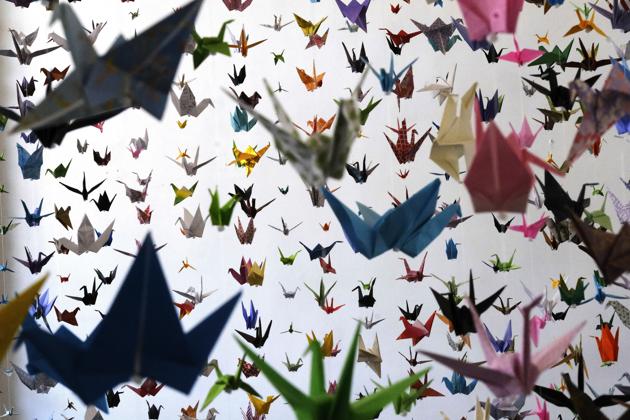 Origami paper cranes hang in the Matter Studio Gallery in Los Angeles during an exhibit for those who have died in the U.S. of COVID-19, on Tuesday, Aug. 11, 2020. Hundreds of origami now hang from the ceiling of Karla Funderburk’s Matter Studio with others sitting on tables and stacked in boxes waiting to be added to the sad reminder of the virus’ toll. (AP Photo/Richard Vogel) (AP)