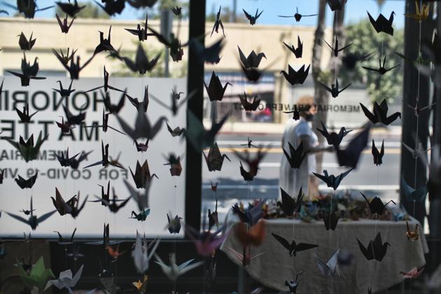 Origami cranes hang inside the Matter Studio Gallery during an exhibit honoring those who have died from COVID-19 in the U.S., Tuesday, Aug. 11, 2020, in Los Angeles. Gallery owner Karla Funderburk started the effort. (AP Photo/Richard Vogel) (AP)