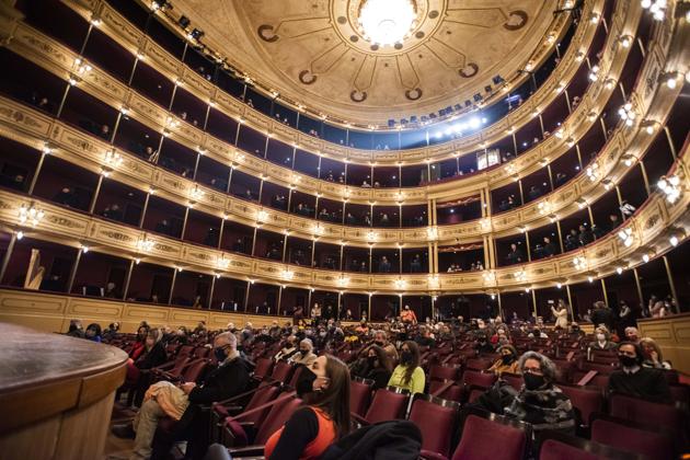People wearing face masks amid the new coronavirus pandemic attend a concert by the Montevideo Symphonic Band at the Solis theatre in Montevideo, Uruguay, Thursday, Aug. 13, 2020. Five months after all the live arts shows were canceled due to the pandemic, the Solis theatre reopened today for a public performance. (AP Photo/Matilde Campodonico) (AP)