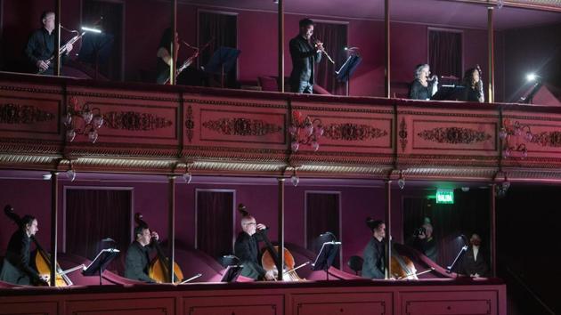 Musicians of the Montevideo Symphonic Band perform from the boxes of the Solis theatre in Montevideo, Uruguay, Thursday, Aug. 13, 2020. Five months after all the live arts shows were canceled due to the new coronavirus pandemic, the Solis theatre reopened today for a public performance. (AP Photo/Matilde Campodonico)