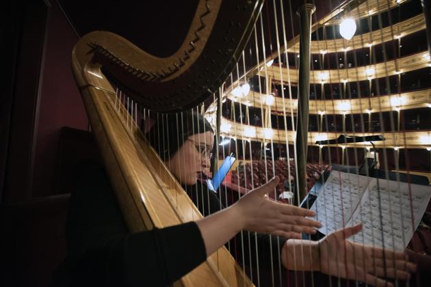 A musician of the Montevideo Symphonic Band plays her harp during a performance at the Solis theatre in Montevideo, Uruguay, Thursday, Aug. 13, 2020. Five months after all the live arts shows were canceled due to the pandemic, the Solis theatre reopened today for a public performance. (AP Photo/Matilde Campodonico) (AP)