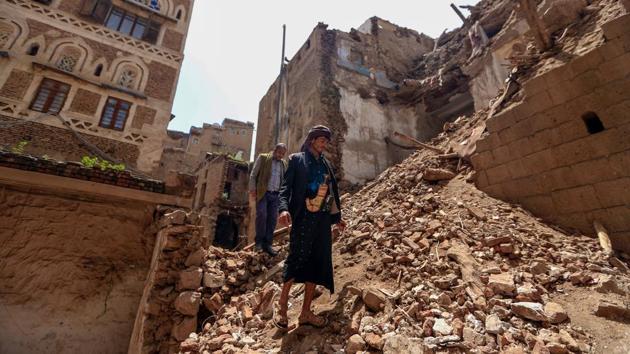 People inspect the site of a collapsed UNESCO-listed building following heavy rains on August 12. Torrential rains have also threatened other UNESCO heritage sites in Yemen, including in Shibam further east, renowned for its high-rise mud-brick “skyscrapers.” In Sanaa, 106 buildings, including five in the Old City, have been destroyed so far and 156 damaged, a source at the Houthi health ministry told AFP. (Mohammed Huwais / AFP)