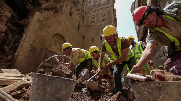 Labourers remove rubble ahead of restoration work on the site of a collapsed UNESCO-listed building in Sanaa on August 12. Flooding is common in Yemen at this time of year, blighting the poorest country on the Arabian peninsula that is in the grips of what the UN calls the world’s worst humanitarian disaster. But the flooding has been particularly severe this year. (Mohammed Huwais / AFP)