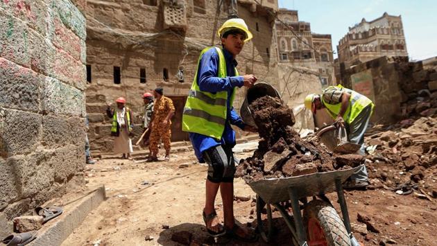 Labourers clean up rubble before restoration work begins in Sanaa’s Old City to repair a collapsed UNESCO-listed building. The 2015 intervention of a Saudi-led coalition in support of the government against the Iran-backed Houthis escalated the conflict on many levels. Coalition warplanes have also been accused of targeting civilians as well as historic sites including the Old City. (Mohammed Huwais / AFP)
