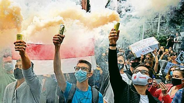 STAND TOGETHER: Members of the Belarus diaspora and Ukrainian activists with smoke grenades during a rally in Kiev.