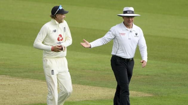 Umpire Richard Kettleborough, right, talks to England's captain Joe Root as they leave the field after rain stopped play on the first day of the second cricket Test match between England and Pakistan, at the Ageas Bowl in Southampton, England, Thursday, Aug. 13, 2020.(AP)
