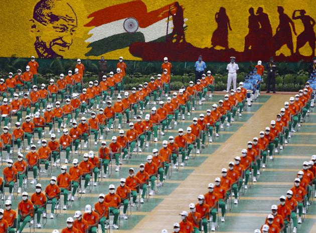 People dressed in the colors of the Indian national flag listens to Prime Minister Narendra Modi speaking from the ramparts of the historic Red Fort monument on Independence Day in New Delhi, India, Saturday, Aug. 15, 2020. (AP)