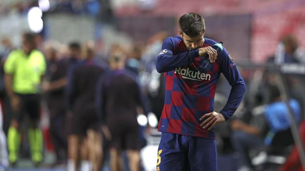 Barcelona's Gerard Pique reacts after the the Champions League quarterfinal soccer match between Barcelona and Bayern Munich in Lisbon, Portugal, Friday, Aug. 14, 2020.(AP)