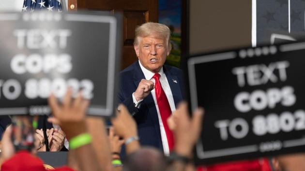 US President Donald Trump pumps his fist as he delivers remarks to the City of New York Police Benevolent Association at the Trump National Golf Club in Bedminster, New Jersey.(AFP)