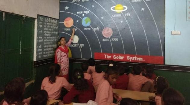 A teacher busy teaching students at a government-run primary school in Prayagraj. (HT file) A teacher busy teaching students at a government-run primary school in Prayagraj. (HT file)