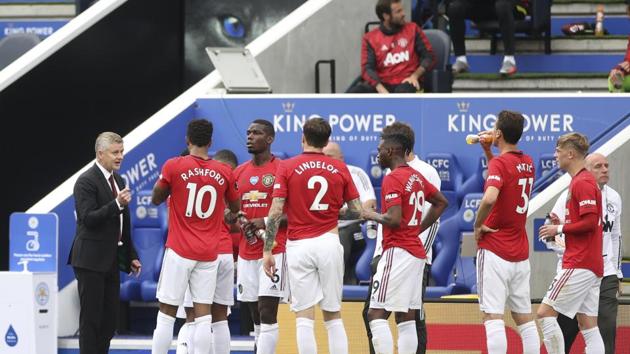 Manchester United's manager Ole Gunnar Solskjaer, left, gives instructions to his players during the English Premier League soccer match between Leicester City and Manchester United at the King Power Stadium, in Leicester, England, Sunday, July 26, 2020. (Carl Recine/Pool via AP) (AP)