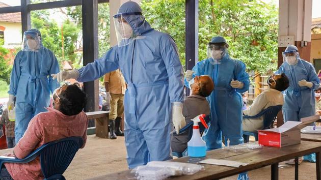 Health workers collect samples for COVID-19 testing, at Karipur International airport in Kozhikode on August 16. India’s case fatality rate (CFR) — the proportion of deaths to the total recorded infections — at 1.9% is however, lower than the global average of 3.5%, indicating that the country has controlled deaths better than other nations with similar or higher caseload. (PTI)