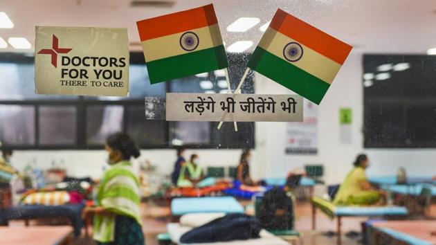 Indian tri-colours pasted on the glass door of the CWG Village COVID care centre in New Delhi on August 15. Scientists believe that until a vaccine is developed, retaining a low death rate while focusing on boosting health care infrastructure and widespread testing remain crucial to controlling Covid-19’s impact in the country. (Kamal Kishore / PTI)