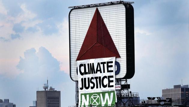 Members of an environmental group hangs a banner that reads “CLIMATE CHANGE NOW” on the iconic Citgo sign near Boston's Fenway Park in Kenmore Square on Monday, Aug. 8, 2020 in Boston.(AP) Members of an environmental group hangs a banner that reads “CLIMATE CHANGE NOW” on the iconic Citgo sign near Boston's Fenway Park in Kenmore Square on Monday, Aug. 8, 2020 in Boston.(AP)