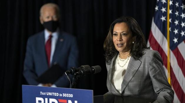 Democratic presidential candidate former Vice President Joe Biden stands left as his running mate Sen. Kamala Harris, D-Calif., speaks at the Hotel DuPont in Wilmington.(AP)
