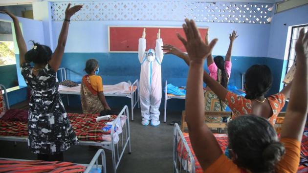 A Nagercoil Corporation worker wearing a PPE kit conducts yoga session at a COVID-19 care centre, in Kanyakumari district on August 14. In the seven days to August 14, India added an average of 934 deaths daily — about 34% hike from the average 615 fatalities added in the week ending July 19, HT reported. (PTI)