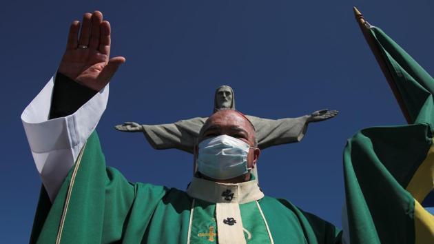 Rio de Janeiro's Archbishop Orani Tempesta gestures as he celebrates a mass in tribute to the victims of the coronavirus disease (COVID-19), on Father's Day, at the Christ the Redeemer statue in Rio de Janeiro, Brazil August 9, 2020. (REUTERS/Ian Cheibub)