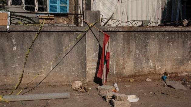 A Lebanese flag hangs outside what remains of a building after the explosion at Karantina in Beirut on August 12. Residents here are struggling to start afresh for lack of financial aid, loss of family and a sense of belonging that the neighbourhood stood for. (Alkis Konstantinidis / REUTERS) A Lebanese flag hangs outside what remains of a building after the explosion at Karantina in Beirut on August 12. Residents here are struggling to start afresh for lack of financial aid, loss of family and a sense of belonging that the neighbourhood stood for. (Alkis Konstantinidis / REUTERS)