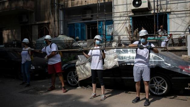 Volunteers carry scaffolding to be set up around a damaged building in Karantina on August 13. According to Reuters, Syrian refugee families and migrant workers that predominantly lived in this area have lost their lives’ savings in the explosion and are now at the mercy of the young volunteers who have flocked to help from across the country. (Alkis Konstantinidis / REUTERS) Volunteers carry scaffolding to be set up around a damaged building in Karantina on August 13. According to Reuters, Syrian refugee families and migrant workers that predominantly lived in this area have lost their lives’ savings in the explosion and are now at the mercy of the young volunteers who have flocked to help from across the country. (Alkis Konstantinidis / REUTERS)