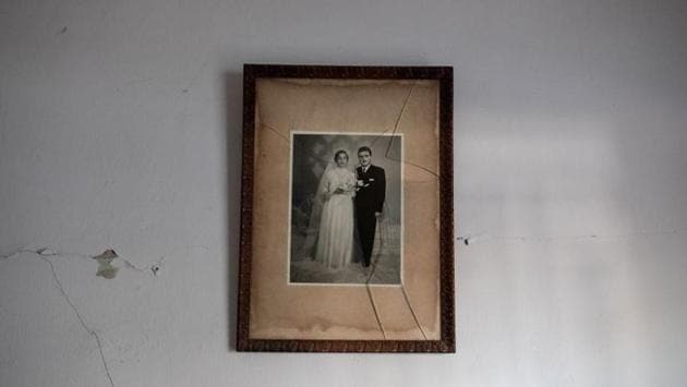 A framed photograph from a wedding hangs in a damaged house at Karantina on August 12. With the wreckage at their doorstep once more after the civil war, families who have spent decades in Karantina are camping in their apartments. They sleep on the floor or on ripped couches, without doors or windows, unsure of how to go on. (Alkis Konstantinidis / REUTERS) A framed photograph from a wedding hangs in a damaged house at Karantina on August 12. With the wreckage at their doorstep once more after the civil war, families who have spent decades in Karantina are camping in their apartments. They sleep on the floor or on ripped couches, without doors or windows, unsure of how to go on. (Alkis Konstantinidis / REUTERS)