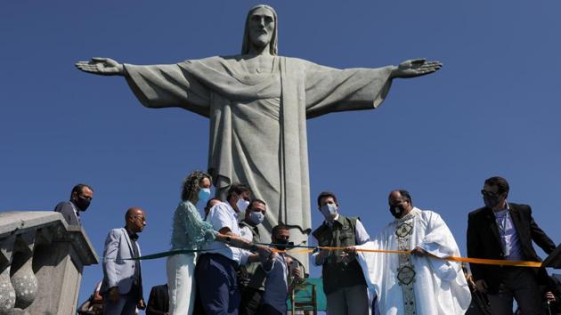 Brazil's Environment Minister Ricardo Salles accompanied by authorities cuts a ribbon during the reopening ceremony of the Christ the Redeemer statue due to the outbreak of the coronavirus disease (COVID-19), in Rio de Janeiro, Brazil August 15, 2020. (REUTERS/Pilar Olivares)