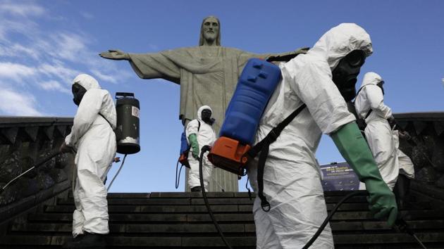 Military members work on disinfection of the Christ the Redeemer statue ahead of its re-opening amid the coronavirus disease (COVID-19) outbreak, in Rio de Janeiro, Brazil, August 13, 2020. (REUTERS/Ricardo Moraes)