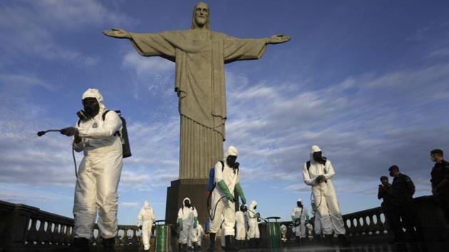 Military members work on disinfection of the Christ the Redeemer statue ahead of its re-opening amid the coronavirus disease (COVID-19) outbreak, in Rio de Janeiro, Brazil, August 13, 2020. (REUTERS/Ricardo Moraes)