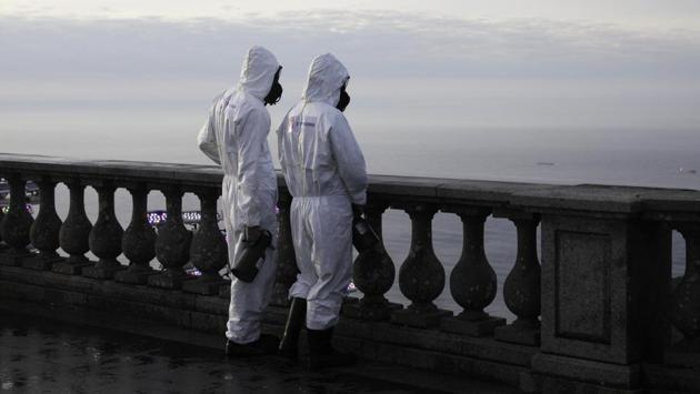 Military members observe the view while working on disinfection of the Christ the Redeemer statue ahead of its re-opening amid the coronavirus disease (COVID-19) outbreak, in Rio de Janeiro, Brazil, August 13, 2020. (REUTERS/Ricardo Moraes)