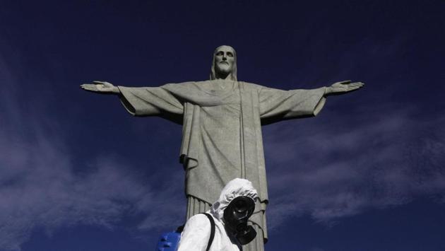 A Military member works on disinfection of the Christ the Redeemer statue ahead of its re-opening amid the coronavirus disease (COVID-19) outbreak, in Rio de Janeiro, Brazil, August 13, 2020. (REUTERS/Ricardo Moraes)