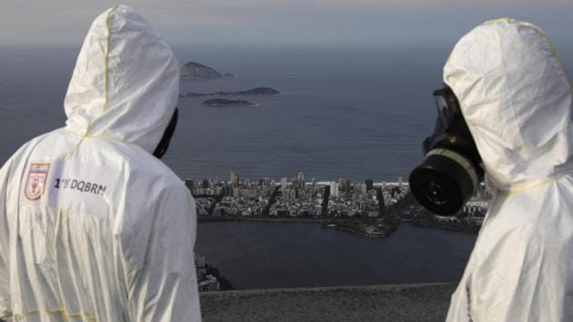 Military members work on disinfection of the Christ the Redeemer statue ahead of its re-opening amid the coronavirus disease (COVID-19) outbreak, in Rio de Janeiro, Brazil, August 13, 2020. (REUTERS/Ricardo Moraes)