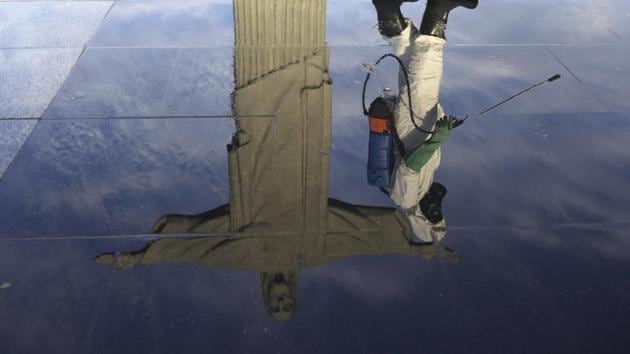 A Military member works on disinfection of the Christ the Redeemer statue ahead its re-opening amid the coronavirus disease (COVID-19) outbreak, in Rio de Janeiro, Brazil, August 13, 2020. (REUTERS/Ricardo Moraes)