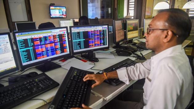 Traders monitor BSE index at a brokerage firm in Mumbai, Monday(PTI File Photo)