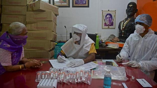 Health take details of a resident at a COVID-19 screening camp in Mumbai on August 17. The Union Ministry has attributed the surge in reported Covid-19 cases to the rampant testing happening all over the country in a bid to stronghold the virus. (Indranil Mukherjee / AFP) Health take details of a resident at a COVID-19 screening camp in Mumbai on August 17. The Union Ministry has attributed the surge in reported Covid-19 cases to the rampant testing happening all over the country in a bid to stronghold the virus. (Indranil Mukherjee / AFP)