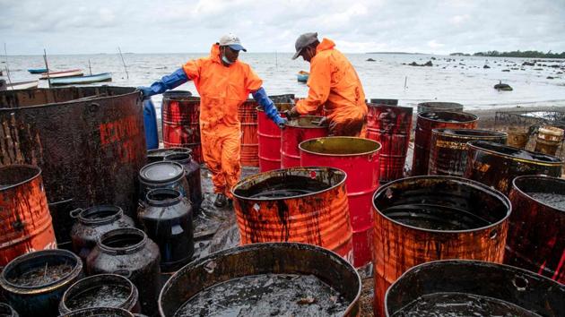 Workers collect leaked oil at the beach in Riviere des Creoles on August 15 in Mauritius. The island nation has declared an environmental emergency and salvage crews are racing against the clock to pump the remaining 3,000 tonnes of oil off the stricken vessel. (Fabien Dubessay / AFP)