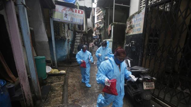 Community health workers arrive to screen people for Covid-19 symptoms in Dharavi, one of Asia's biggest slums, in Mumbai.(AP)