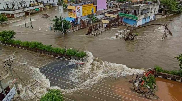 Flooded streets and submerged houses after heavy rainfall, in Warangal district on Sunday.(PTI)